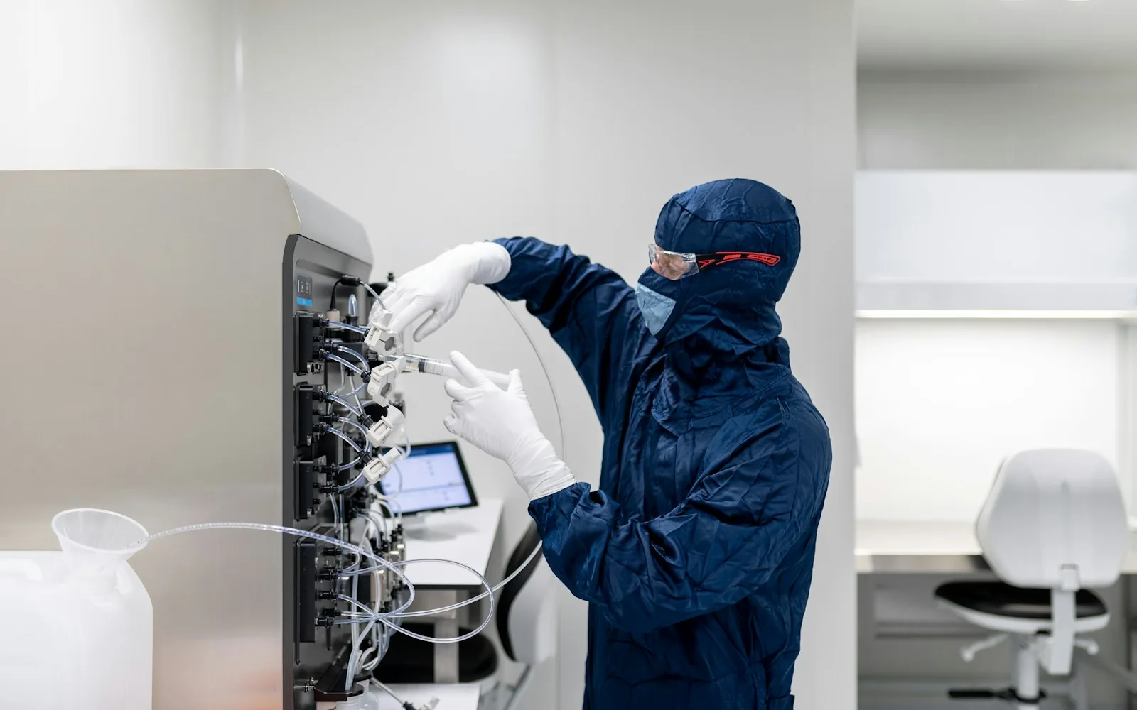 Cleanroom operative working at laboratory equipment